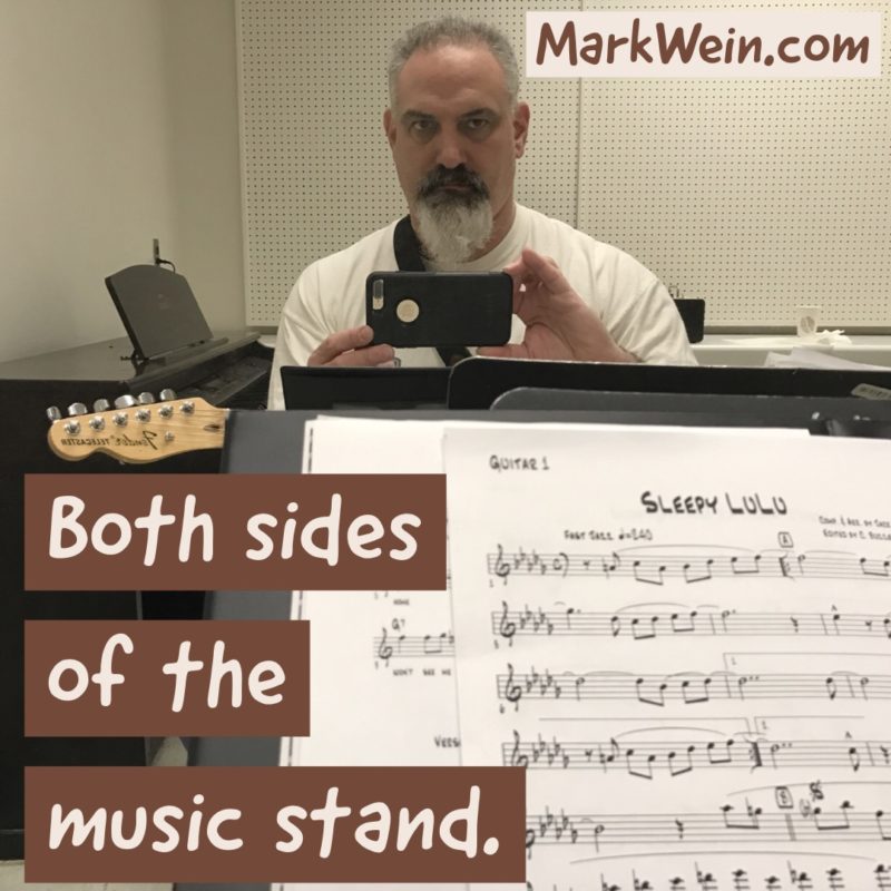 Sitting on both sides of the music stand.